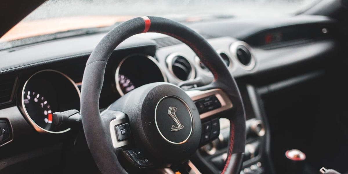 Close-up of a car steering wheel, dashboard and center console.