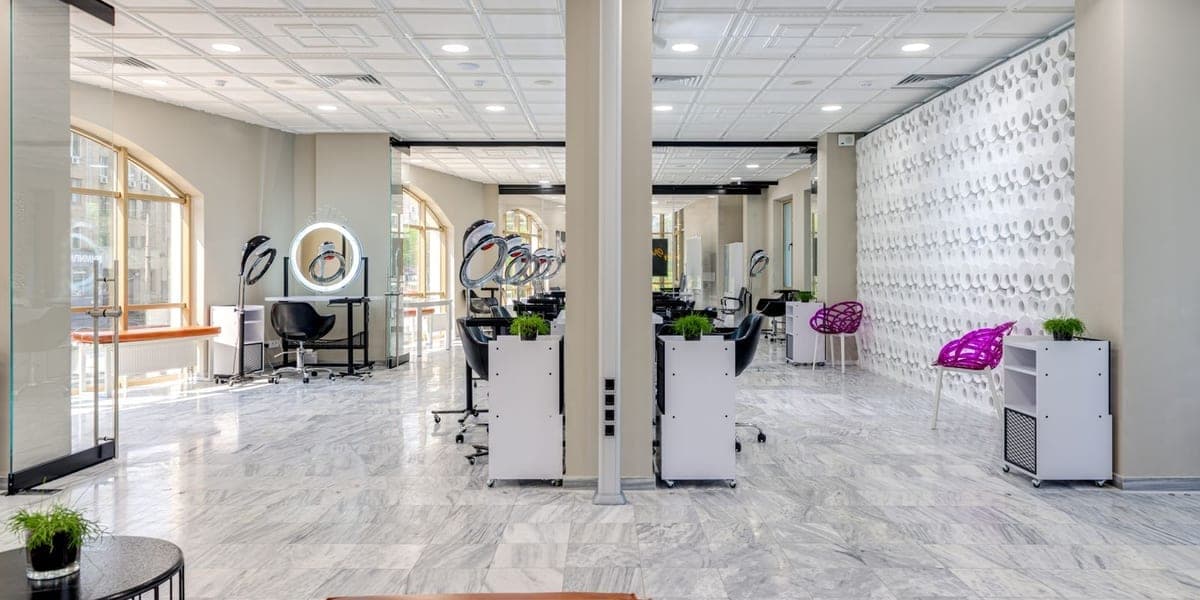 Empty styling chairs and mirrors inside a hair salon